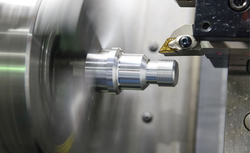 Image of a machining tool spinning fast in a factory